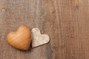 Wooden heart symbol on wooden background